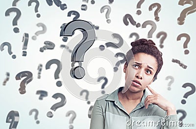 African girl and floating question marks on sunny day Stock Photo