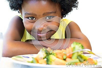 African girl in front of vegetable dish. Stock Photo