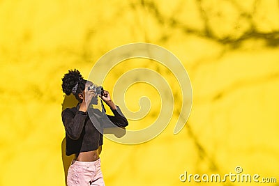 African girl photographer making picture in street Stock Photo