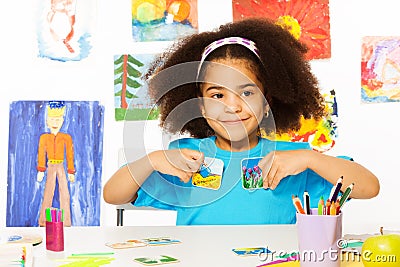 African girl plays developmental game, holds cards Stock Photo