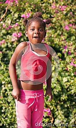 african girl with ponytails jumping in the garden Stock Photo