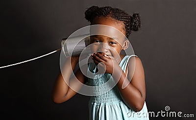 African girl with a tin and string on her ear Stock Photo