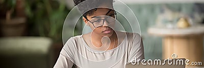 African girl wear glasses looking at pc screen studying online Stock Photo