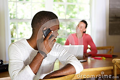 African guy making a phone call and looking back at woman Stock Photo