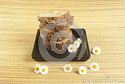 African handmade black soap with white flowers Stock Photo