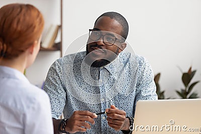 African hr manager listening to caucasian applicant at job interview Stock Photo