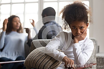 African kid daughter upset of parents fighting looking at camera Stock Photo