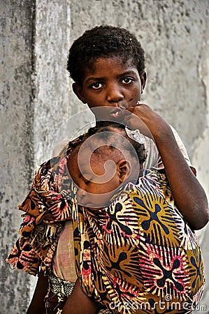 African little cute girl carrying baby brother Editorial Stock Photo