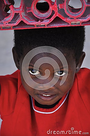 African little cute girl carrying box on his head Editorial Stock Photo