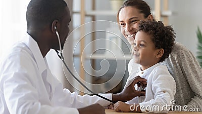 African male pediatrician hold stethoscope exam child boy patient Stock Photo