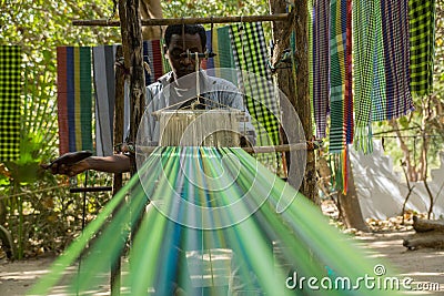 An african male performing traditional weaving in Gambia Stock Photo