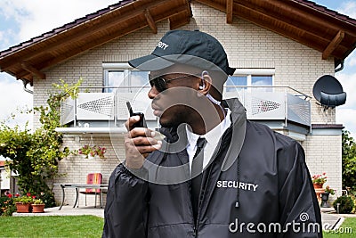 African Male Security Guard Talking On Walkie Talkie Stock Photo