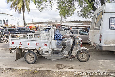 African man on a cargo tricycle on a busy street on the island of Zanzibar, Tanzania, East Africa Editorial Stock Photo