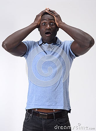 African man with expression of forgetfulness or surprise on white background Stock Photo