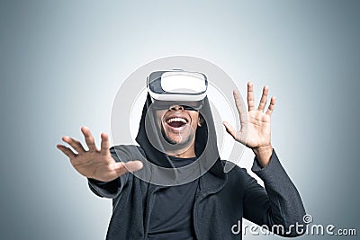 African man playing a vr game near a gray wall Stock Photo