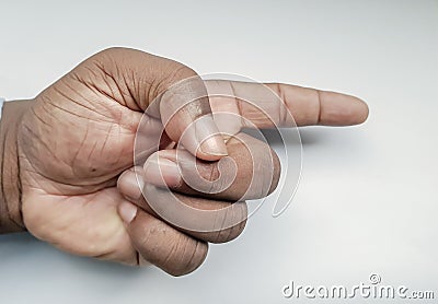 Man`s hand with forefinger pointing at something in the left direction Stock Photo