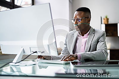 African Man Using Phone With Nasal Oxygen Cannula Stock Photo