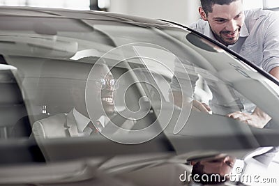 An African man who buys a new car checks a car talking to a professional vendor. Stock Photo