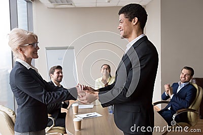 African manager holding hand of successful caucasian worker express respect Stock Photo