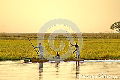 Men poling a wooden canoe Editorial Stock Photo