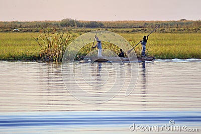 Men poling a wooden canoe Editorial Stock Photo