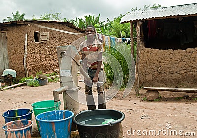 African rural teenage boy collecting water Editorial Stock Photo