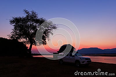 African safari in own cars with tents on the roof, sleeping on the riverside of Zambezi in Zimbabwe, star trails on the sky and Editorial Stock Photo