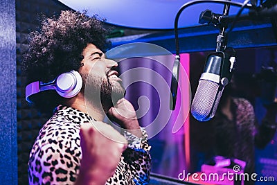 African singer recording new music album inside boutique studio - Main focus on face Stock Photo