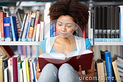African student girl reading book at library Stock Photo