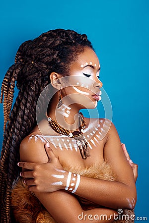 African style . Attractive young woman in ethnic jewelry . close up portrait of a woman with a painted face. Creative make up Stock Photo