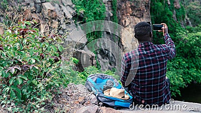 African traveler taking selfie from top of the mountain Stock Photo