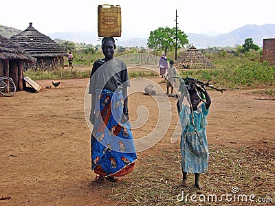 African woman & child villagers doing daily work & chores village life Editorial Stock Photo