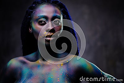 African woman with colourful powder on her face and body Stock Photo