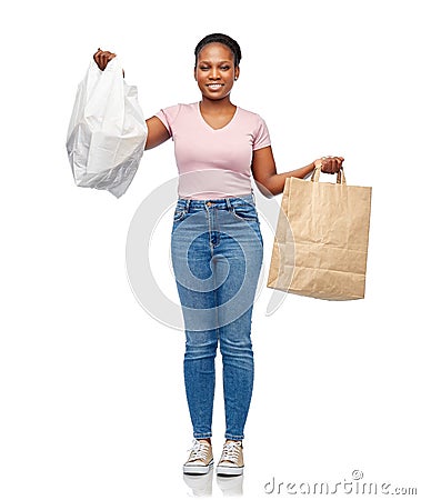 african woman comparing paper and plastic bags Stock Photo