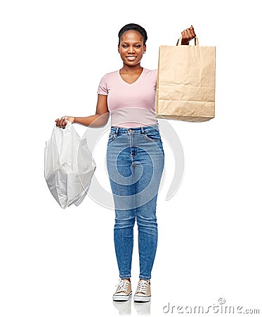 african woman comparing paper and plastic bags Stock Photo