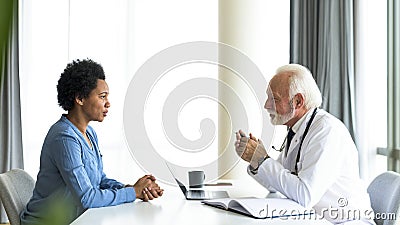 African woman consulting doctor about her medical condition Stock Photo