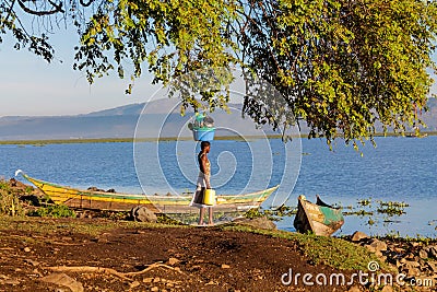 African woman wash clothes on the shore of Lake Victoria Editorial Stock Photo