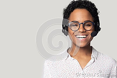 African woman wearing headset with microphone posing isolated on grey Stock Photo