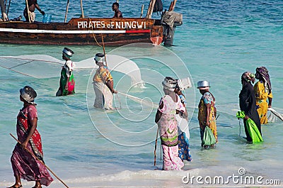 African women from a fishing village to catch small fish nets in the ocean Editorial Stock Photo