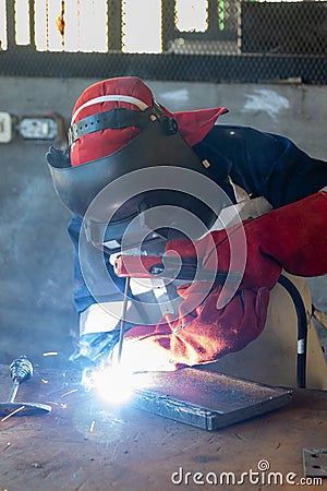 African worker welder with red gloves Stock Photo