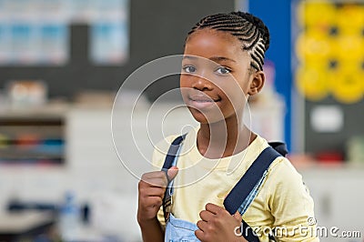 Girl wearing backpack at school Stock Photo