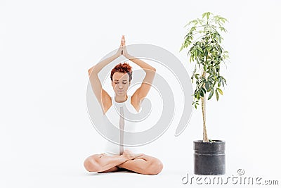 African young woman sitting in lotus pose and practicing yoga Stock Photo
