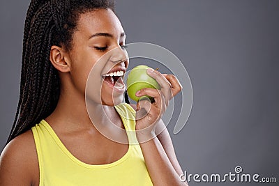 Afro-American female biting apple Stock Photo