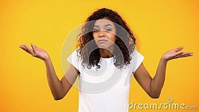 Afro-american female showing no idea gesture, unsure of choice, hesitation Stock Photo