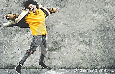 Afro American man having fun dancing in city center - Happy young guy jumping and enjoying positive moments Stock Photo