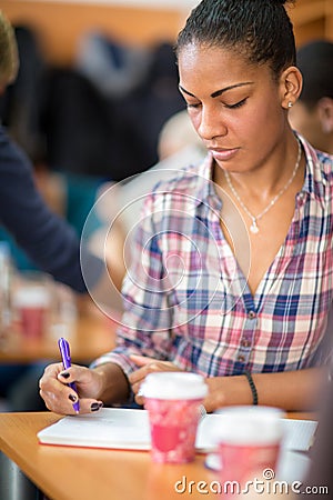 Afro American student studying and noting on class Stock Photo