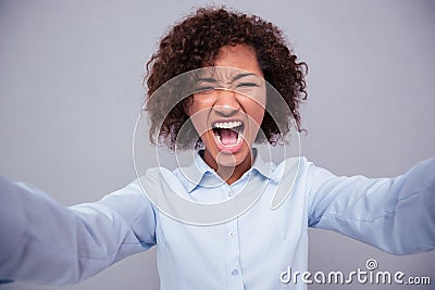 Afro american woman screaming and making selfie photo Stock Photo
