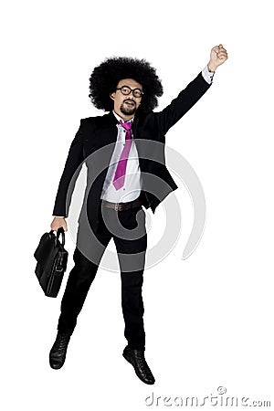 Afro businessman leaps in studio Stock Photo