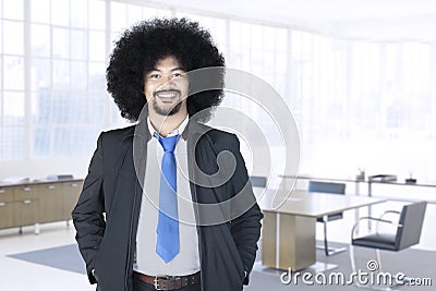 Afro businessman standing in office Stock Photo