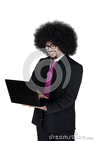 Afro businessman using a laptop in studio Stock Photo